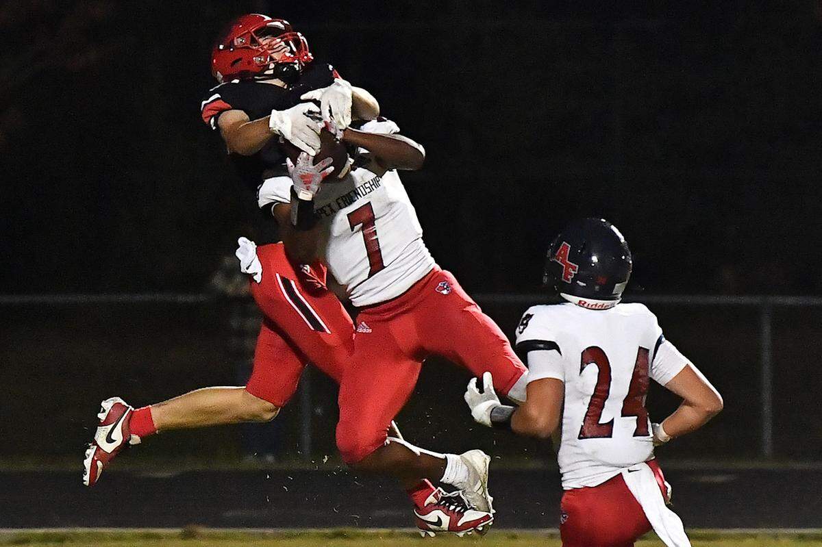 Apex Friendship’s Jayden Butler (7) makes the interception in the end zone against Middle Creek’s Nicolas Bocciardi (12) during the second half. The Middle Creek Mustangs and the Apex Friendship Patriots met in a football game in Cary, N.C. on October 25, 2024.