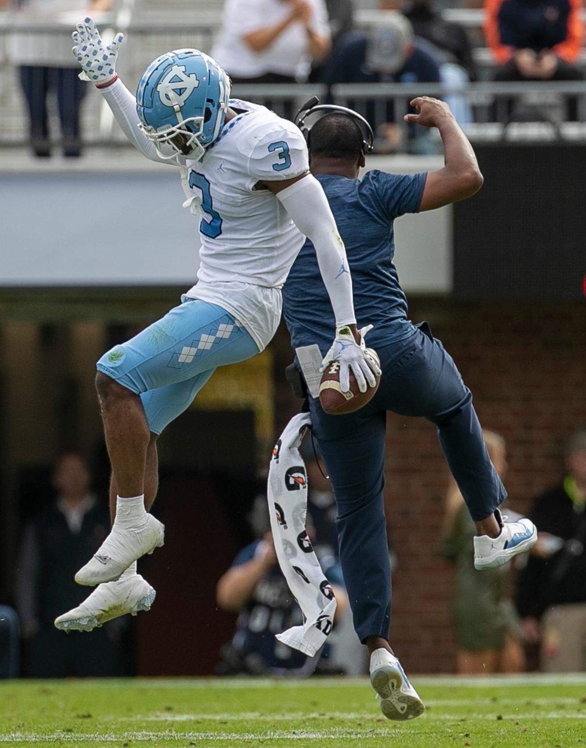 North Carolina cornerbacks coach Dre Bly celebrates with Storm Duck (3) after his interception of Virginia quarterback Brennan Armstrong in the first quarter on Saturday, November 5, 2022 at Scott Stadium in Charlottesville, Va.