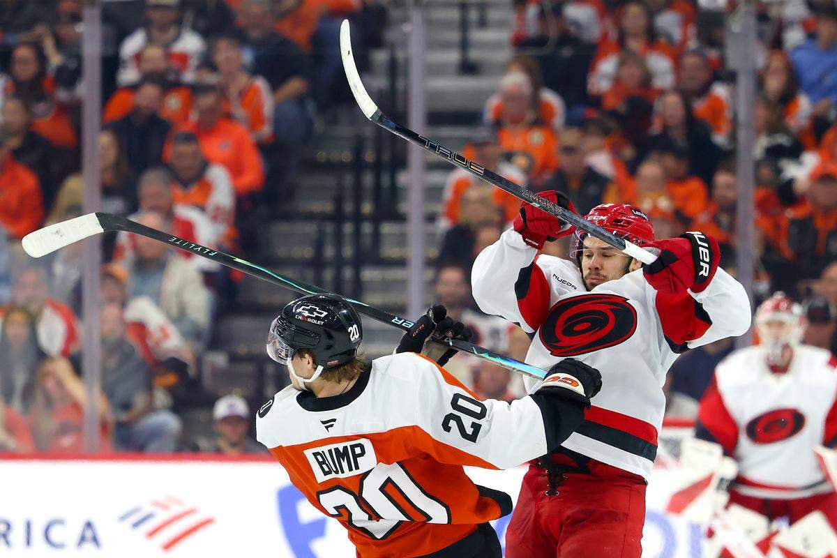 Logan Stankoven (22) of the Carolina Hurricanes collides with Alex Bump of the Philadelphia Flyers during the third period of Game 4 of the teams’ second-round Stanley Cup Playoff series at Xfinity Mobile Arena on May 9, 2026 in Philadelphia, Pennsylvania.