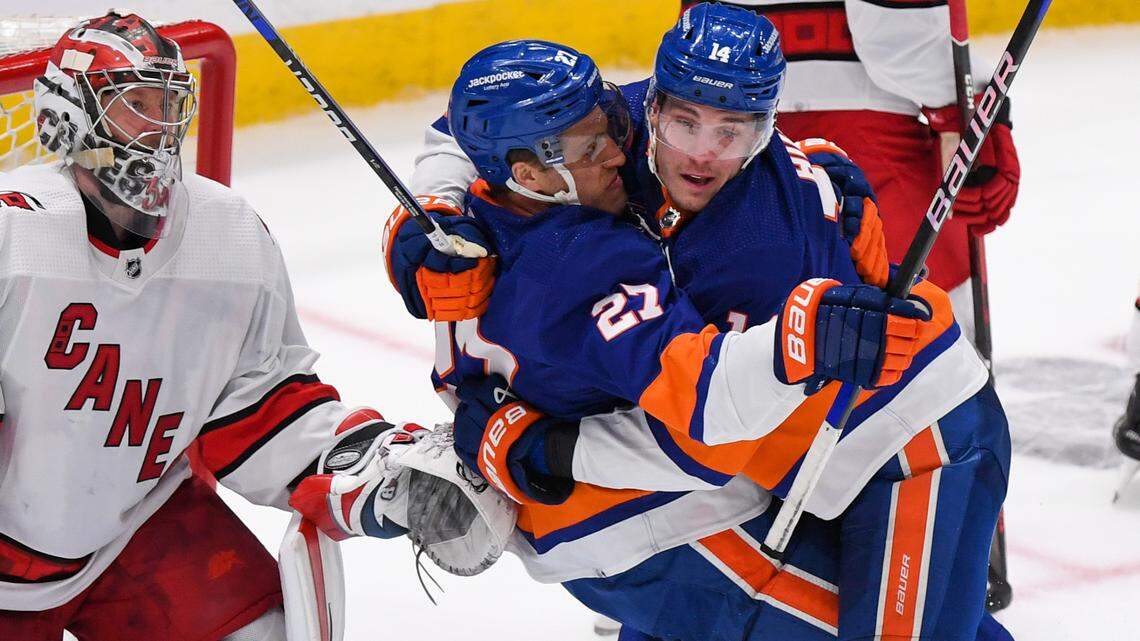 New York Islanders center Bo Horvat (14) celebrates the goal by left wing Anders Lee (27) against the Carolina Hurricanes during the third period in game three of the first round of the 2023 Stanley Cup Playoffs at UBS Arena.
