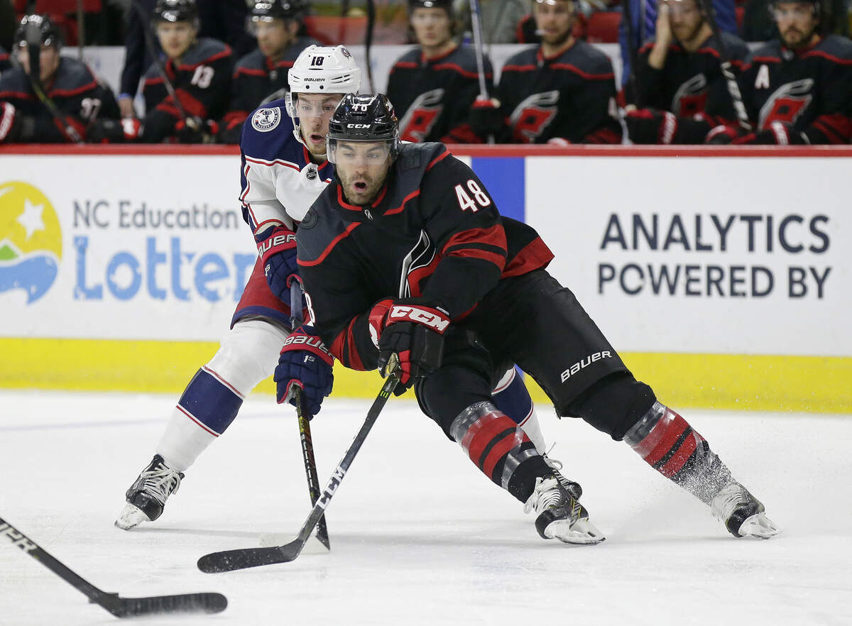 Carolina Hurricanes’ Jordan Martinook (48) and Columbus Blue Jackets’ Pierre-Luc Dubois (18) chase the puck during the first period of an NHL hockey game in Raleigh, N.C., Friday, Jan. 4, 2019. (AP Photo/Gerry Broome)