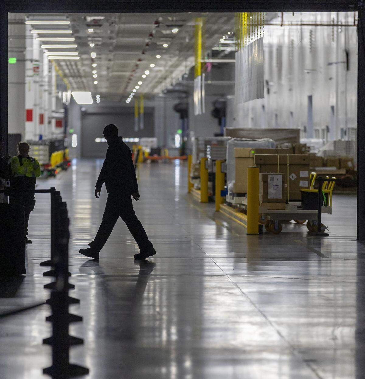 A Toyota battery plant employee walks inside building 802 on Wednesday, November 12, 2025 in Liberty, N.C. The massive $13.9 billion battery plant celebrated the start of production on Wednesday, with a host of dignitaries including Gov. Josh Stein, Senator Ted Budd and U.S. Secretary of Transportation Sean Duffy.