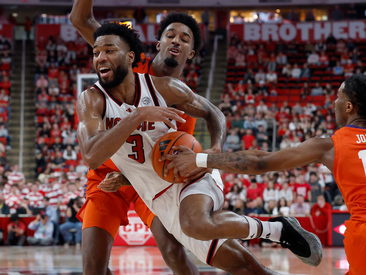 N.C. State’s Dontrez Styles drives between Clemson’s Chauncey Wiggins and Del Jones during the second half of the Wolfpack’s 68-58 loss on Saturday, Feb. 1, 2025, at Lenovo Center in Raleigh, N.C.