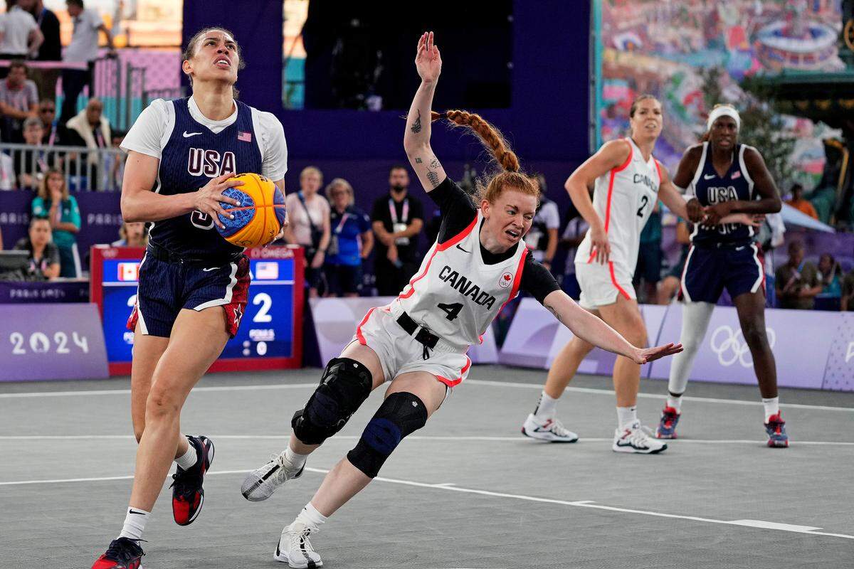 Aug 5, 2024; Paris, France; United States player Dearica Hamby (5) drives to the basket against Canada player Kacie Bosch (4) in the women’s 3x3 basketball bronze medal game during the Paris 2024 Olympic Summer Games at La Concorde 1.