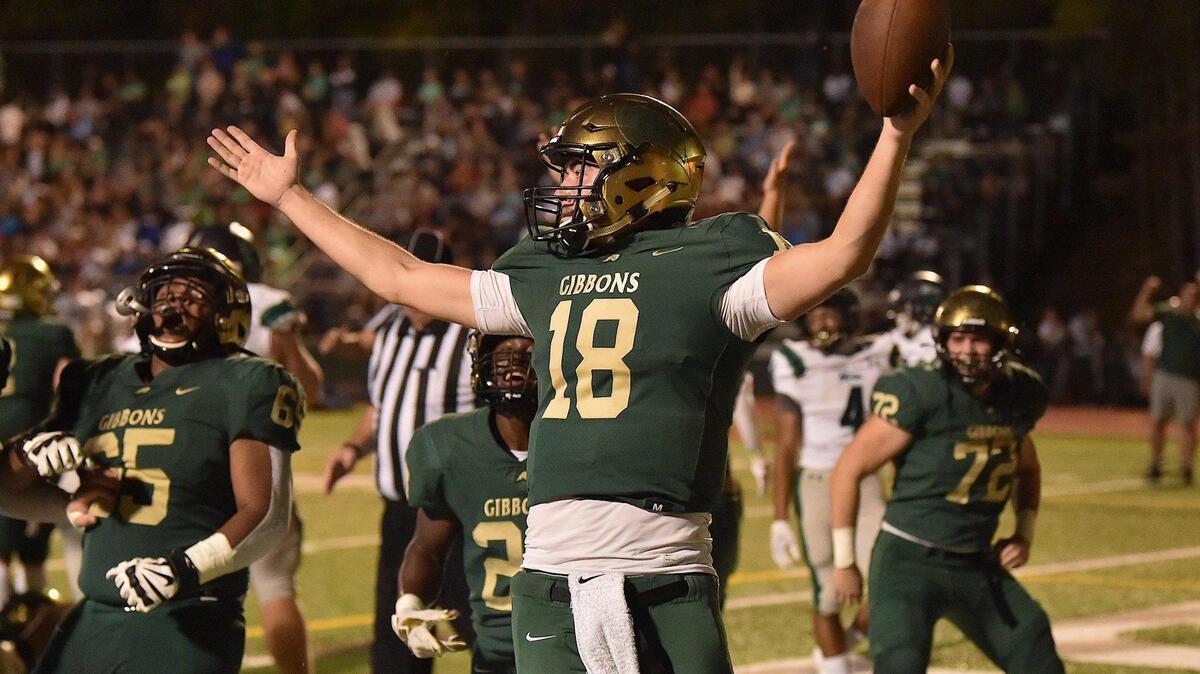 Cardinal Gibbons quarterback Connor Clark (18) celebrates after scoring the touchdown in the fourth quarter.The Cardinal Gibbons Crusaders and the Leesville Road Pride met in a football game in Raleigh , N.C. on October 8, 2021.