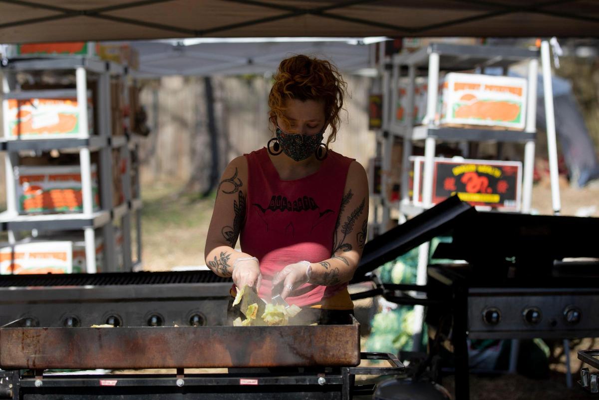 Abigail Porter cooks cabbage on second day of the five-day no-contact cookout known as Feed Durham that began as a response to the increase of food insecurity at the start of coronavirus pandemic, bringing dozens of volunteers together every six to eight weeks to cook well-seasoned and nutrient-dense meals for people in need, on Wednesday, Mar. 3, 2021, in Durham, N.C.