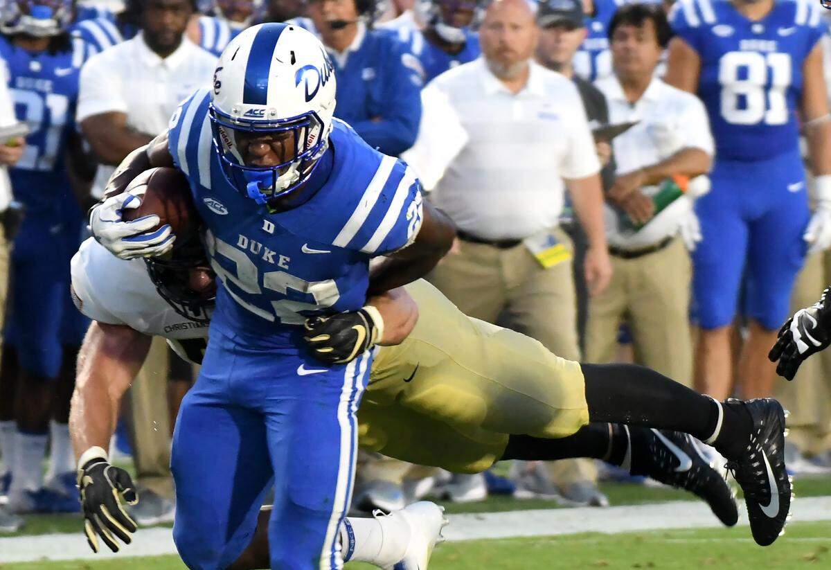 Duke running back Brittain Brown (22) attempts to avoid Army linebacker Cole Christiansen (54) in the first half of play. Duke opened the 2018 football season against Army at Wallace Wade Stadium in Durham, N.C., Friday, August 31, 2018.