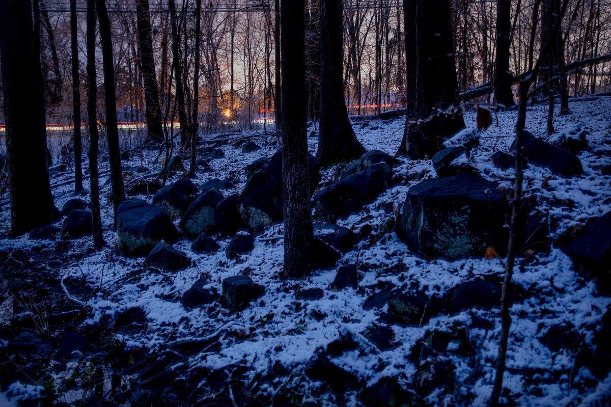 Snow covers rocks along a creek early Thursday morning, Jan. 28, 2021, in Durham, N.C. 