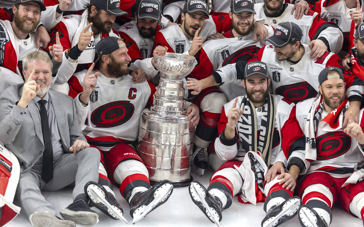 Carolina Hurricanes center Sebastian Aho (20) reaches over to touch the Stanley Cup, during a team photo following their 3-0 victory over Vegas in Game 6 on Sunday, June 14, 2026 at T-Mobile Arena in Las Vegas, NV.