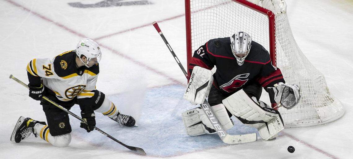Carolina Hurricanes goalie Pyotr Kochetkov deflects a shot attempt by Bostons Jake DeBrusk (74) in the third period on Wednesday, May 4, 2022 during game two of their Stanley Cup first round series at PNC Arena in Raleigh, N.C.