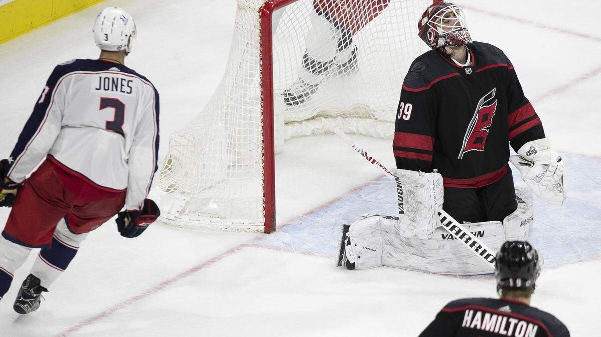 Carolina Hurricanes’ goalie Alex Nedeljkovic (39) reacts as Columbus Blue Jackets’ Seth Jones (3) scores in overtime to give Columbus a 3-2 victory on Thursday, March 18, 2021 at PNC Arena in Raleigh, N.C.