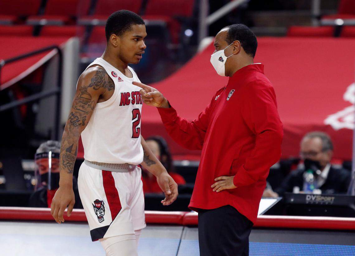 N.C. State head coach Kevin Keatts talks with Shakeel Moore (2) during the second half of Miami’s 64-59 victory over N.C. State at PNC Arena in Raleigh, N.C., Saturday, January 9, 2021.