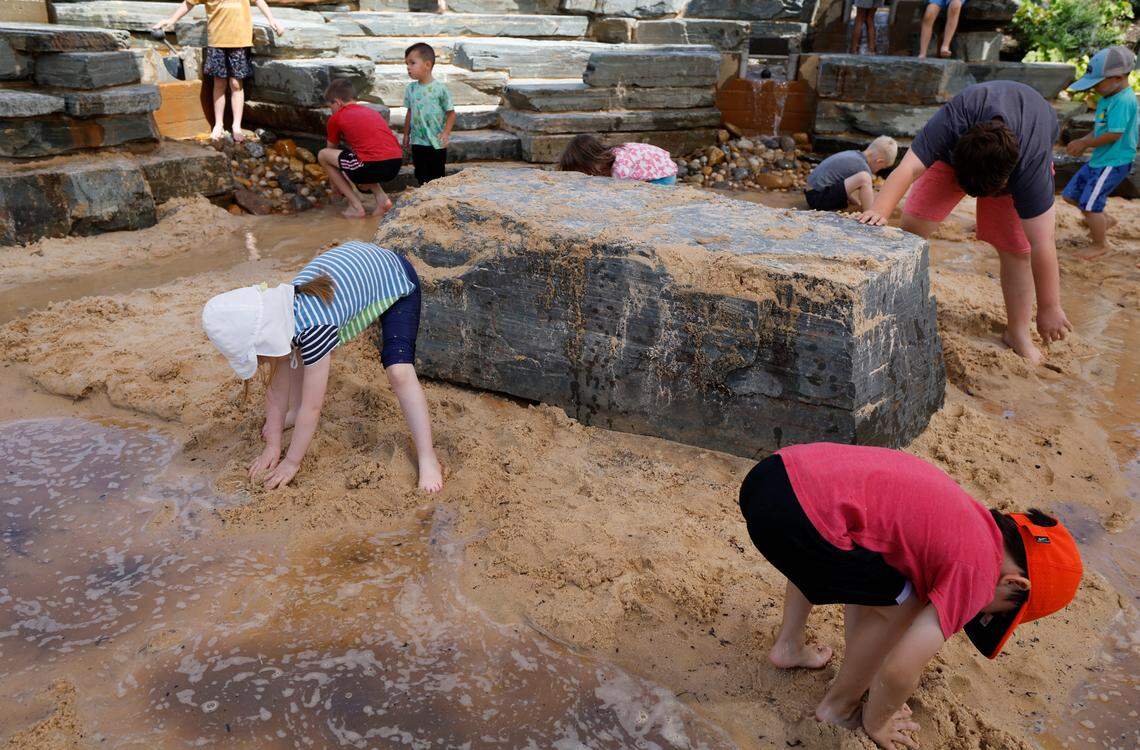 Children enjoy the sand and water at Gipson Play Plaza at Dix Park during a preview day Saturday, May 24, 2025. The park will officially open with a grand opening celebration on June 6th, 7th and 8th.