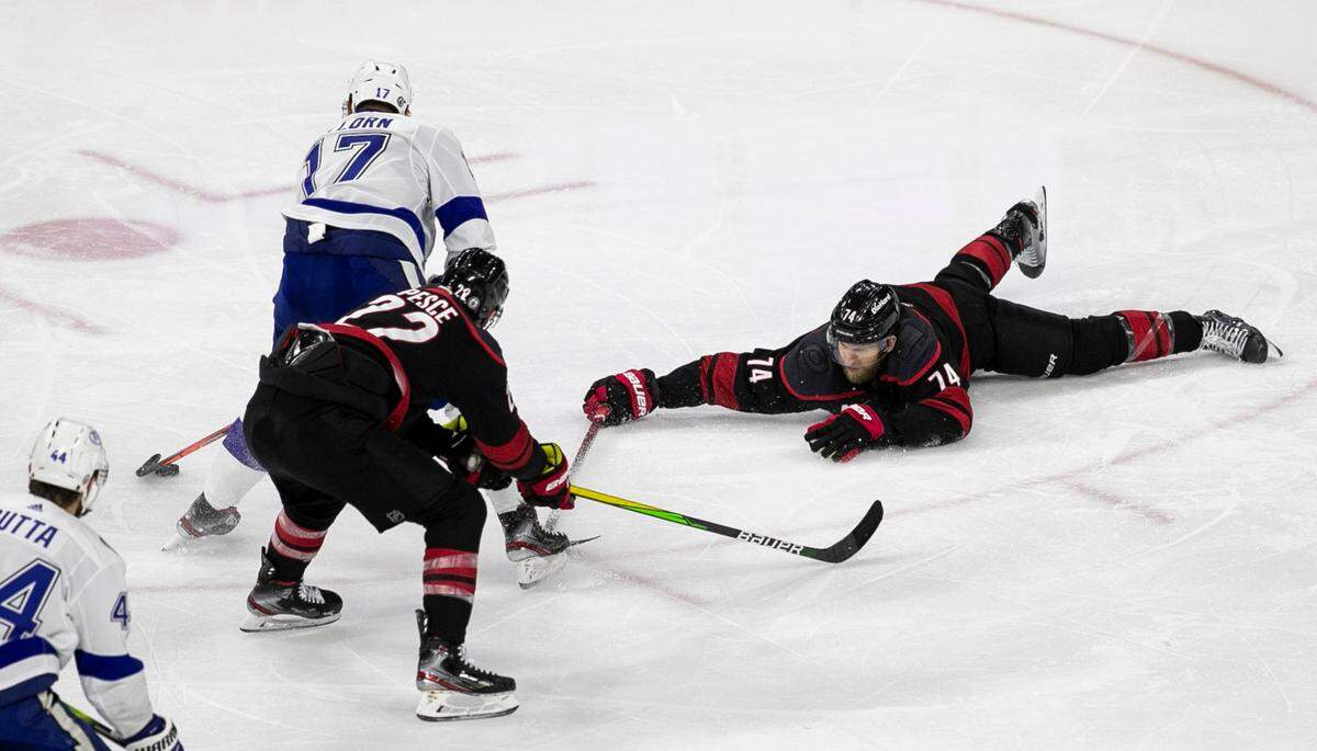 Carolina Hurricanes’ Jaccob Slavin (74) dives in front of Tampa Bay’s Alex Killorn (17) as he charges to the goal in the third period in game two of their second round Stanley Cup series on Tuesday, June 1, 2021 at PNC Arena in Raleigh, N.C.