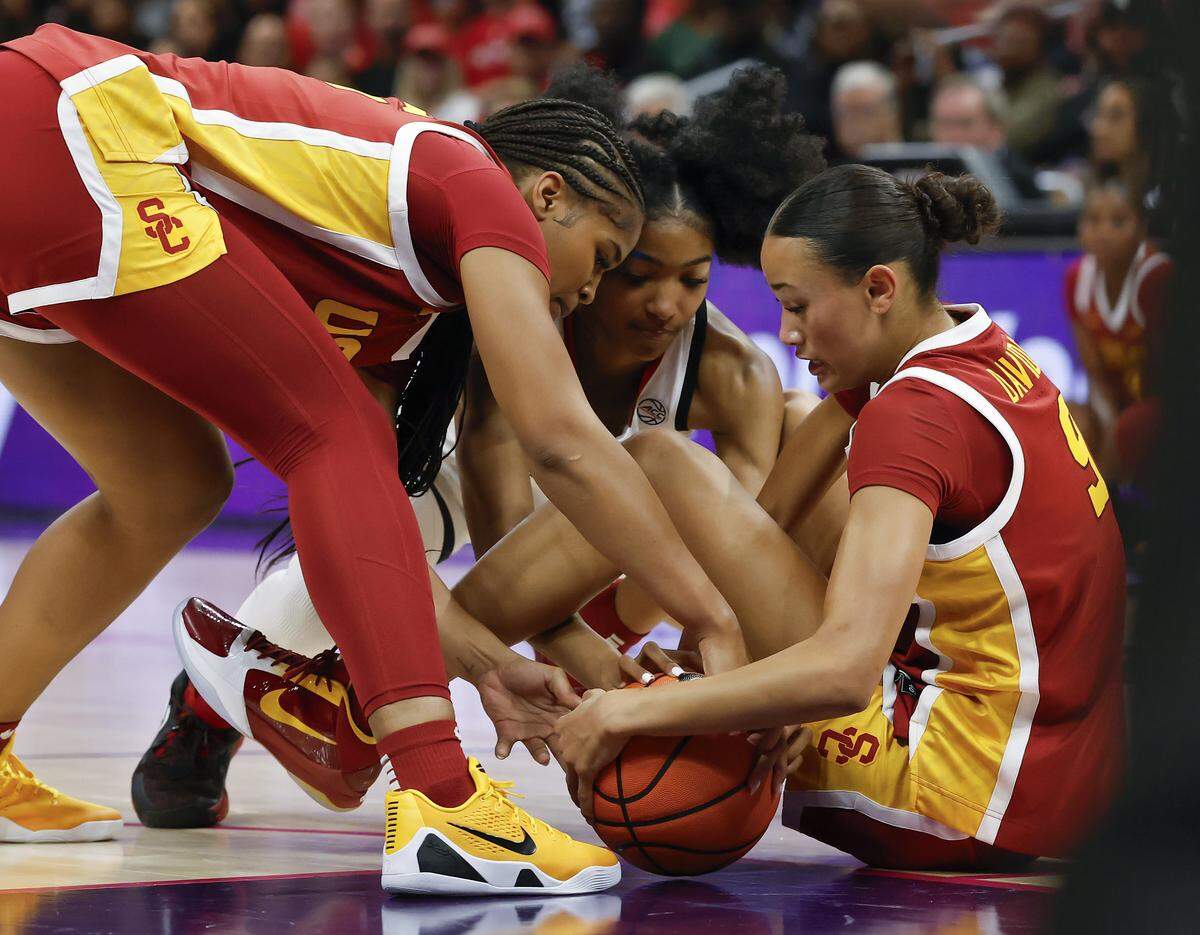 N.C. State’s Qadence Samuels fights for possession with Southern California’s Kara Dunn and Jazzy Davidson during the first half of the Wolfpack’s 69-68 loss in the Ally Tipoff game on Sunday, Nov. 9, 2025, at Spectrum Center in Charlotte, N.C.
