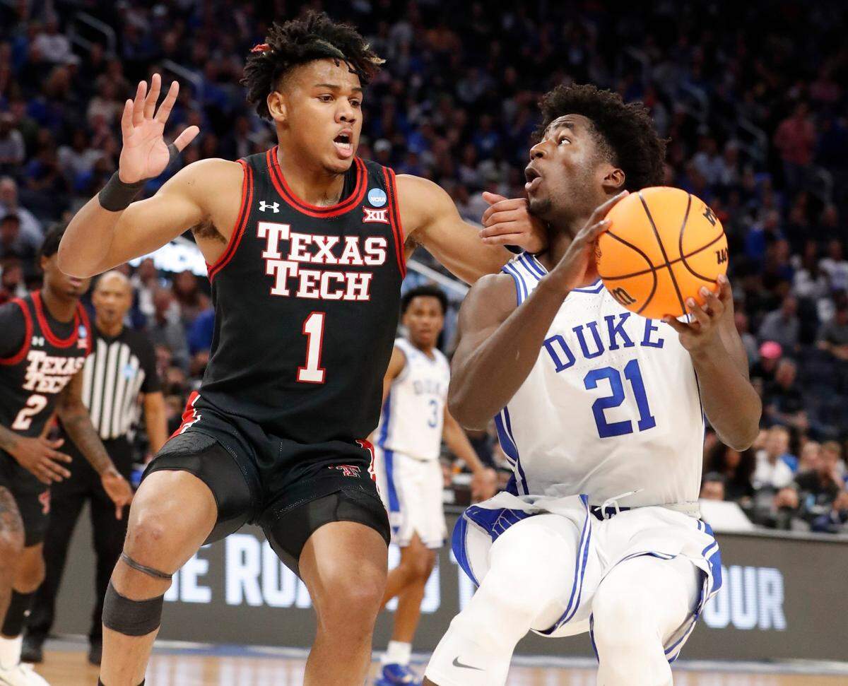 Dukes AJ Griffin (21) heads to the basket as Texas Tech’s Terrence Shannon Jr. (1) defends during the first half of Dukes game against Texas Tech in the Sweet 16 round of the NCAA Tournament at the Chase Center in San Francisco, Calif., Thursday, March 24, 2022.