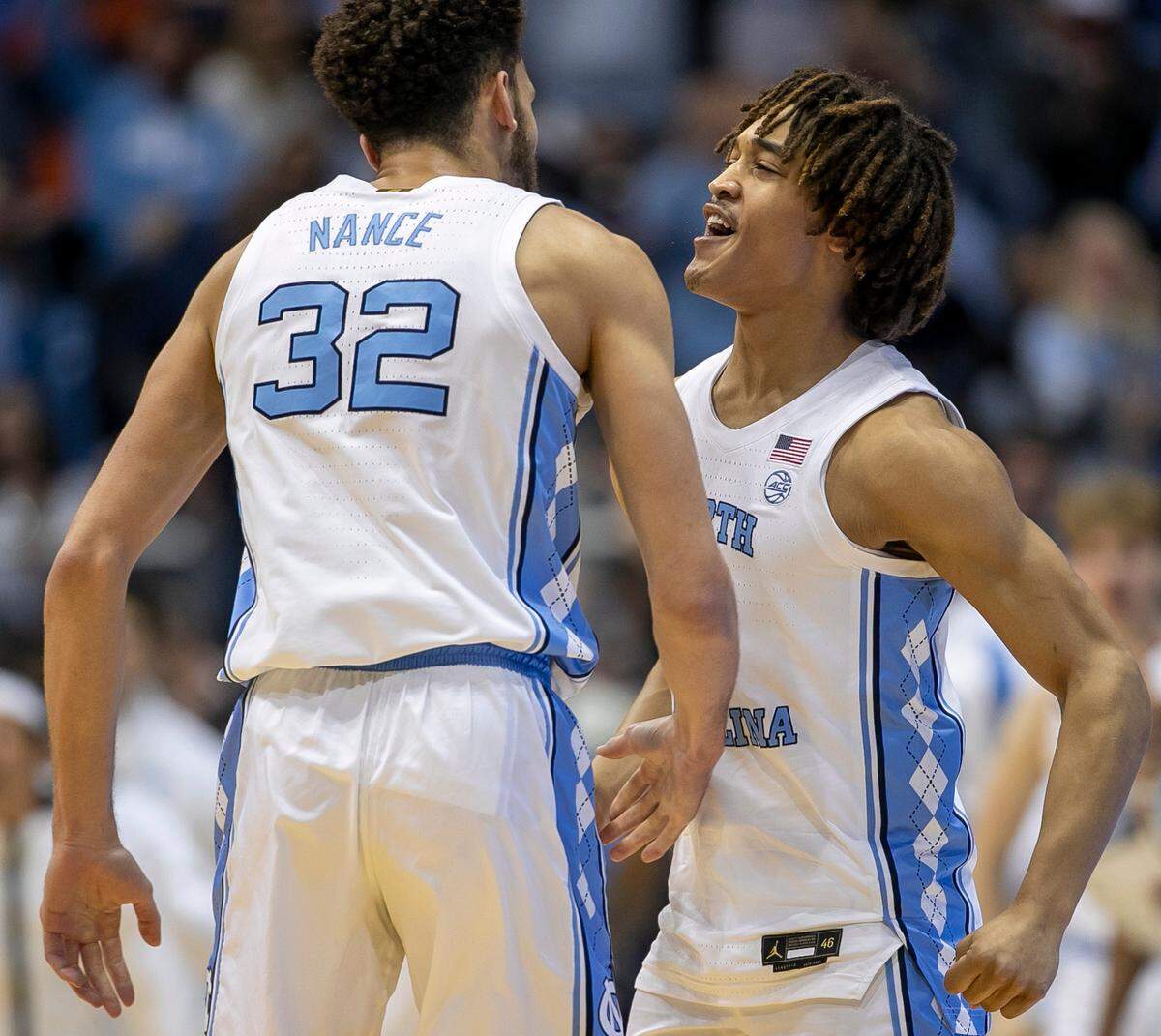 North Carolina’s Seth Trimble (0) chest bumps Pete Nance (32) after a basket in the first half against Virginia on Saturday, February 25, 2023 at the Smith Center in Chapel Hill, N.C.