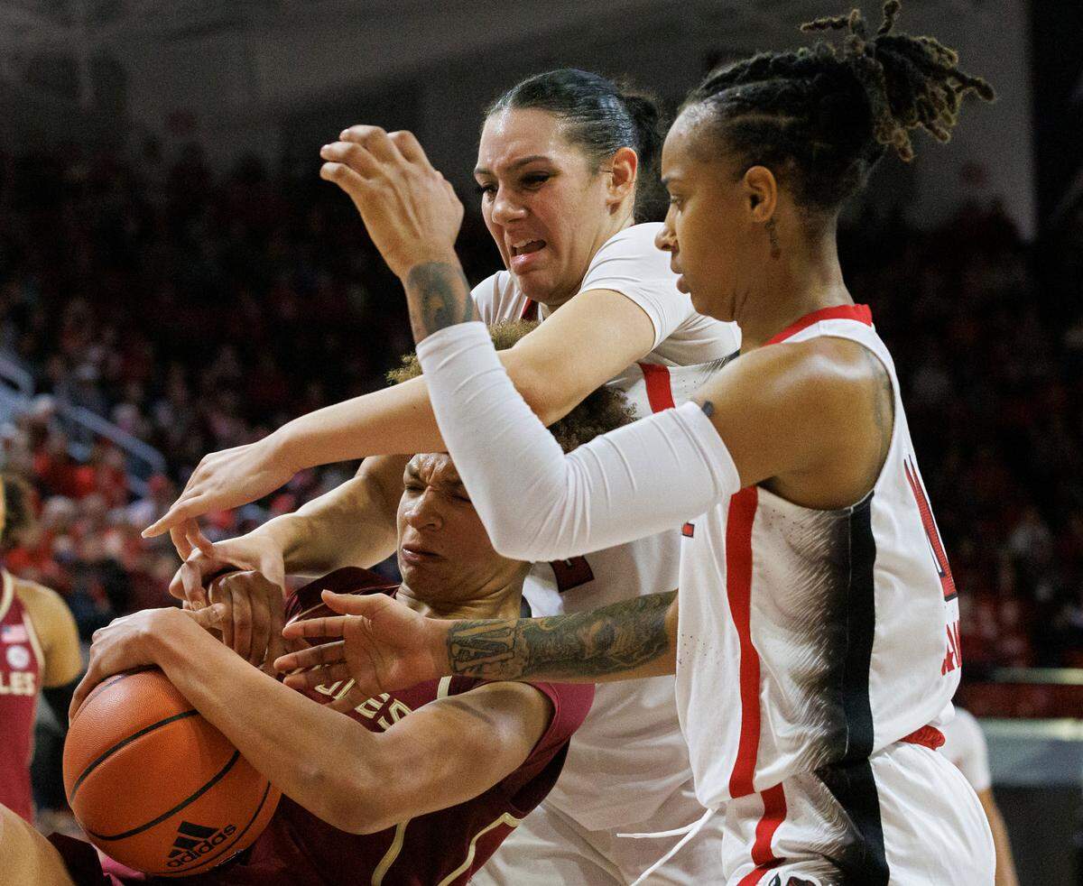 N.C. State’s Mimi Collins and Aziaha James battle for a rebound with Florida State’s Makayla Timpson during the second half of the Wolfpack’s 88-80 win on Thursday, Jan. 4, 2023, at Reynolds Coliseum in Raleigh, N.C.