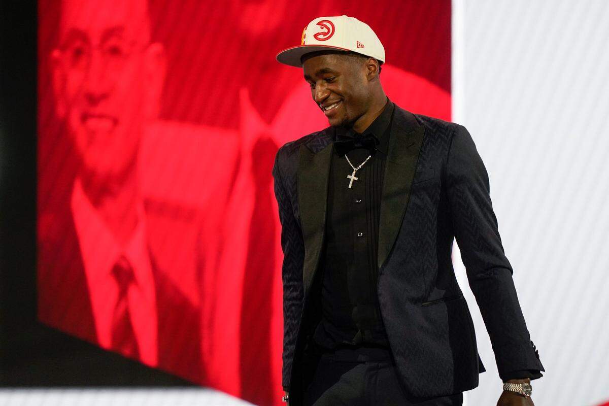 A.J. Griffin walks across the stage after being selected 16th overall by the Atlanta Hawks in the NBA basketball draft, Thursday, June 23, 2022, in New York. (AP Photo/John Minchillo)