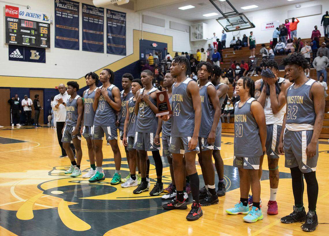 The Kinston High School varsity basketball team stands together for a picture after losing to Farmville Central High School in the 2-A East Regional final game at Lee County High School in Sanford, N.C. on Saturday, March 5, 2022.