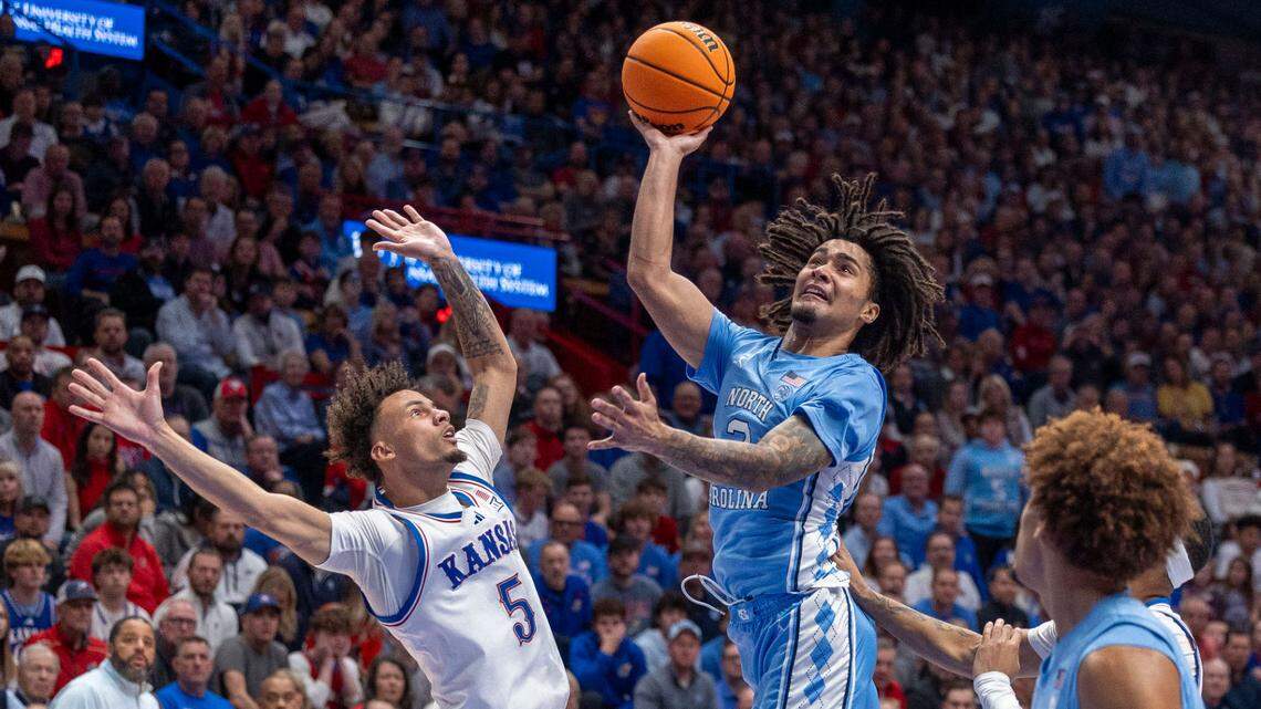 North Carolina guard Elliot Cadeau (3) drives to the basket against Kansas guard Zeke Mayo (5) in the second half on Friday, November 8, 2024 at Allen Fieldhouse in Lawrence, Kansas.