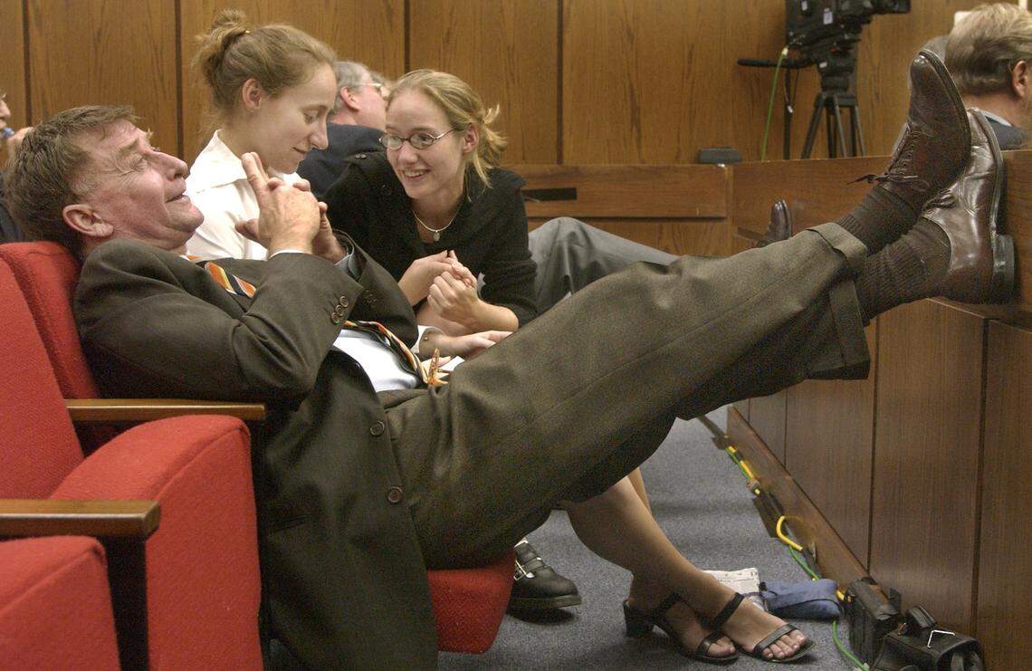 Michael Peterson on Oct. 6, 2003 during his murder trial in Durham, NC. At right is Martha Ratliff and at center is Margaret Ratliff, the two young women Peterson has reared from childhood.