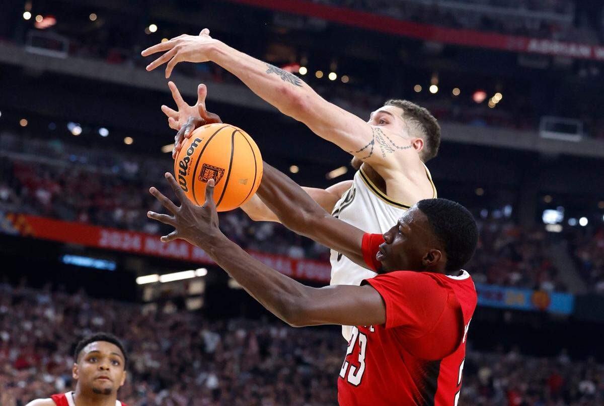 N.C. State’s Mohamed Diarra (23) pulls in the ball from Purdue’s Mason Gillis (0) during the first half of N.C. State’s game against Purdue in the NCAA Tournament national semfinals at State Farm Stadium in Glendale, Ariz., Saturday, April 6, 2024.