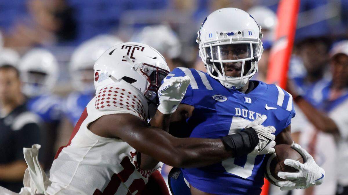 Duke wide receiver Jalon Calhoun (5) runs the ball past Temple linebacker Layton Jordan (13) during the first half of the Blue Devils season opener at Wallace Wade Stadium on Friday, Sept. 2, 2022, in Durham, N.C.