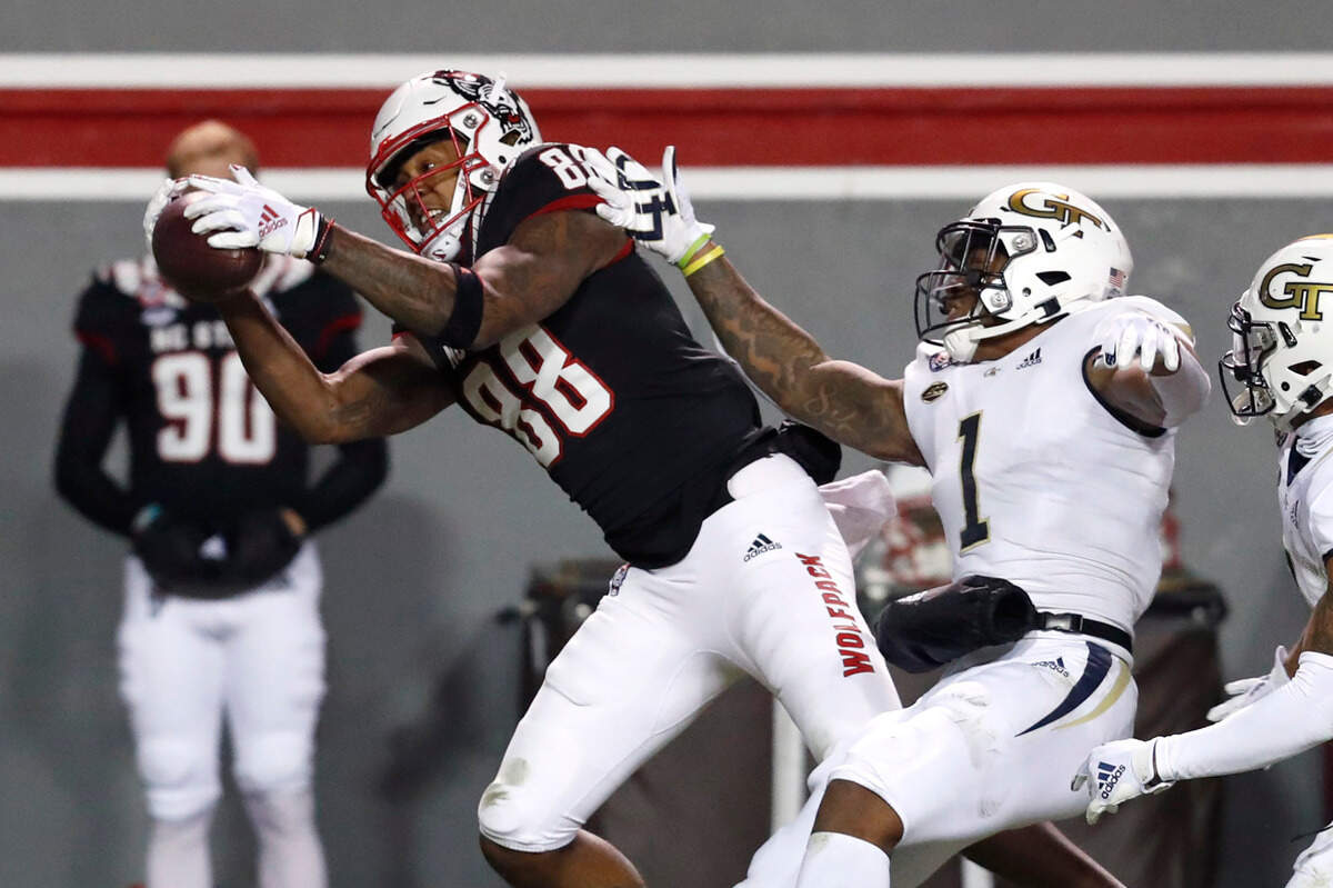 N.C. State wide receiver Devin Carter (88) makes the reception as Georgia Tech defensive back Juanyeh Thomas (1) defends during the first half of N.C. State’s game against Georgia Tech at Carter-Finley Stadium in Raleigh, N.C., Saturday, Dec. 5, 2020.