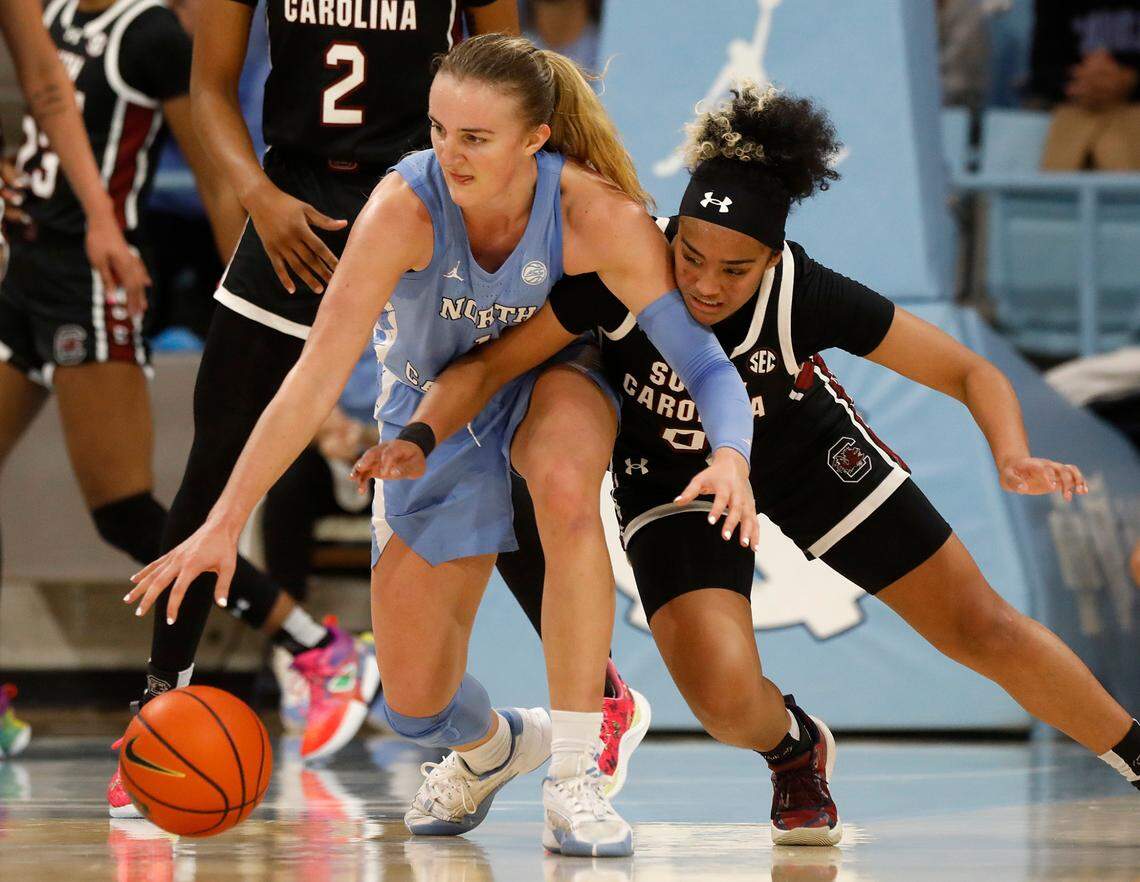 North Carolina’s Alyssa Ustby and South Carolina’s Te-Hina Paopao lunge for a loose ball during the second half of the Tar Heels’ 65-58 loss on Thursday, Nov. 30, 2023, at Carmichael Arena in Chapel Hill, N.C.