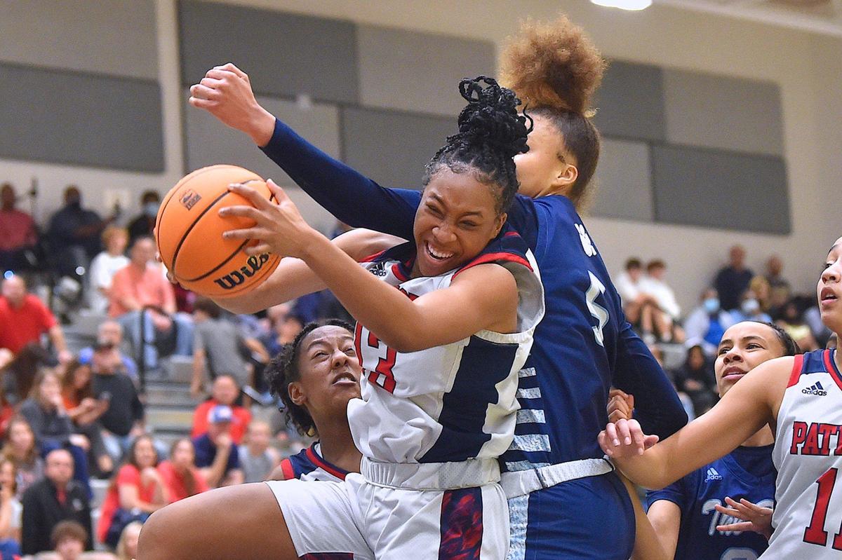 Apex Friendship’s Jada Coleman (13) controls the rebound against Millbrook’s Reychel Douglas (5) in the first half. The Millbrook Wildcats and the Apex Friendship Patriots met in the NCHSAA 4A Girls East Regional Finals in Cary, N.C. on March 5, 2022.