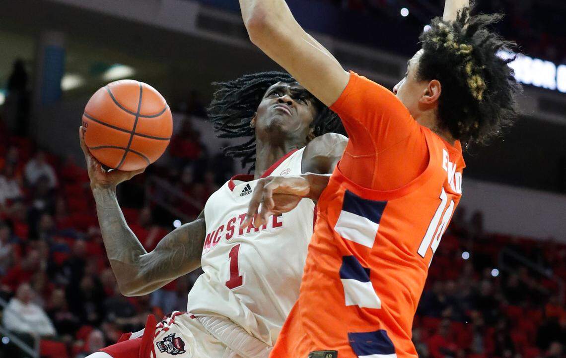 N.C. State’s Dereon Seabron (1) heads to the basket as Syracuse’s Jesse Edwards (14) defends during the second half of Syracuse’s 89-82 victory over N.C. State at PNC Arena in Raleigh, N.C., Wednesday, Feb. 2, 2022.