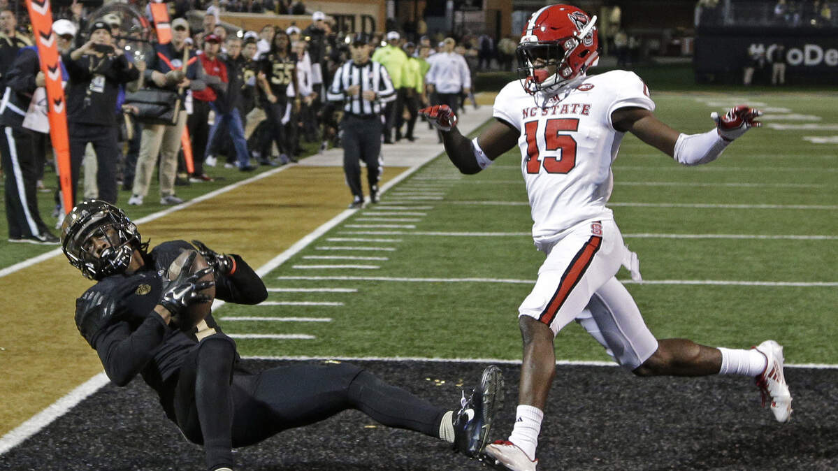 Wake Forest’s Tabari Hines (1) catches a touchdown pass as NC State’s Chris Ingram (15) defends during the second half of a 30-24 Wake Forest win on Nov. 18, 2017.