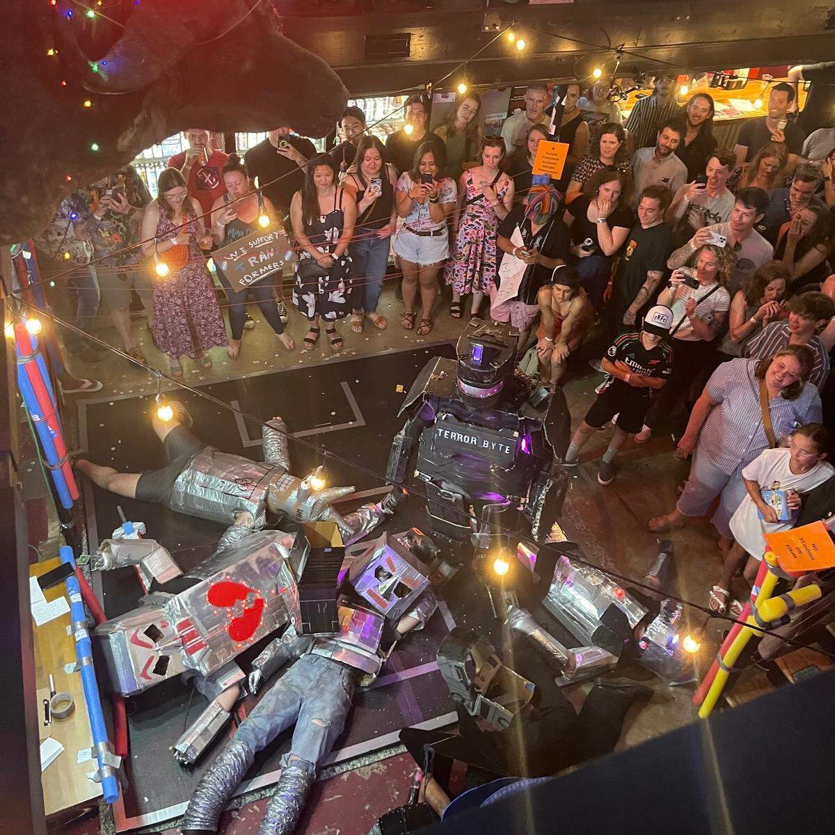 The robot Terrorbyte stands in the mechanized carnage he has created, a scene from Durham’s Giant Robot Fight Club.