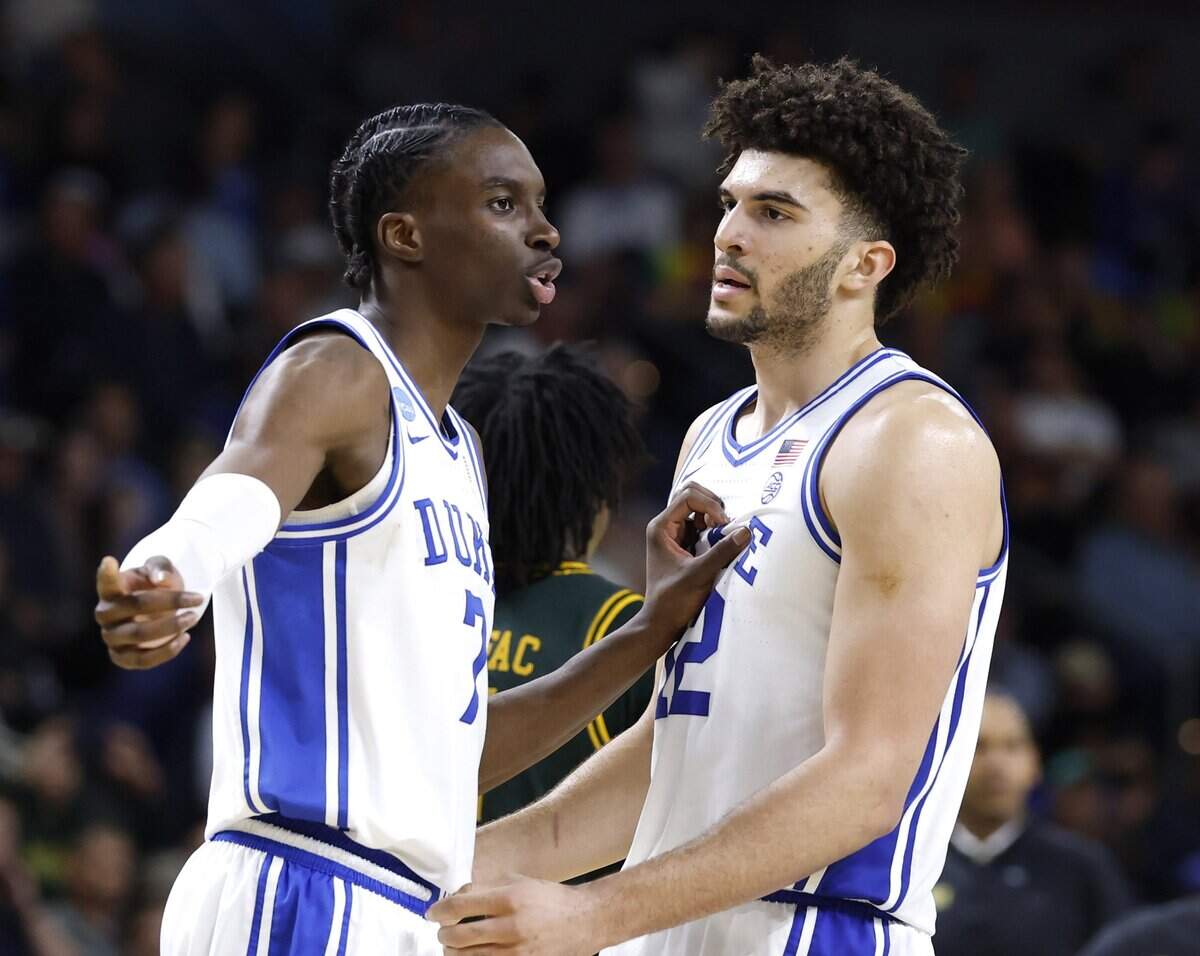 Duke’s Dame Sarr (7) talks to Cameron Boozer (12) during the second half of Duke’s 71-65 victory over Siena in the first round of the NCAA Men’s Basketball Tournament at  Bon Secours Wellness Arena in Greenville, S.C., Thursday, March 19, 2026.