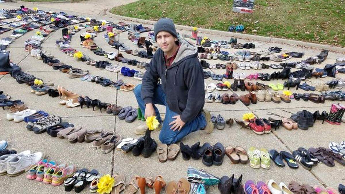 Christopher Carnes with the cowboy boots he donated in memory of his late uncle, who recently died in a crash with a distracted driver. It was part of World Day of Remembrance for Road Traffic Victims, Sunday, Nov. 18, at the State Capitol in Raleigh.