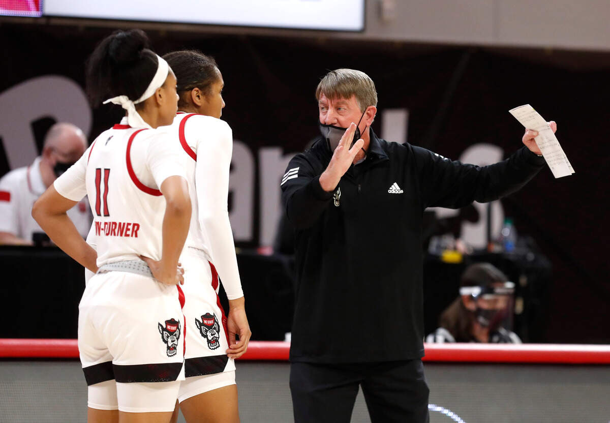N.C. State head coach Wes Moore talks with N.C. State’s Jakia Brown-Turner (11), left and Camille Hobby (41) during the second half of N.C. State’s 89-87 victory over Virginia Tech at Reynolds Coliseum in Raleigh, N.C., Sunday, January 24, 2021.