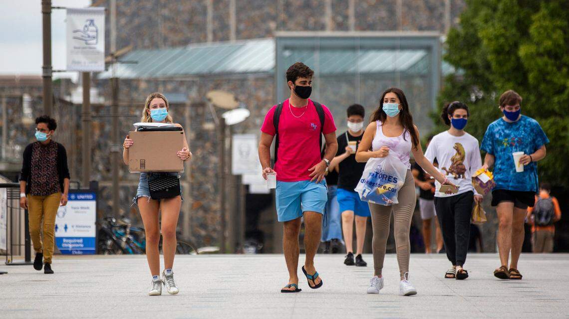 Wearing masks to prevent the spread of COVID-19, students make their way through campus at Duke University on Tuesday, Sept. 1, 2020, in Durham, N.C.