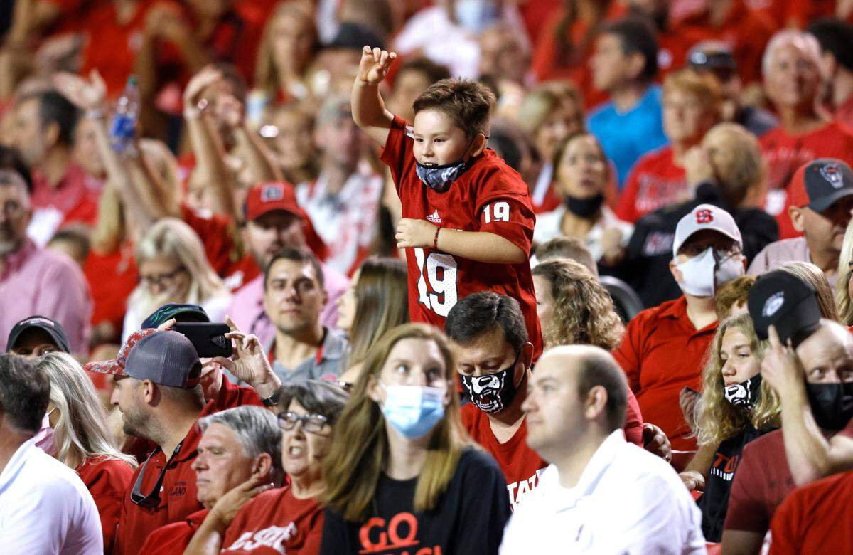 Wolfpack fans cheer on the team during the second half of N.C. State’s 45-0 victory over USF at Carter-Finley Stadium in Raleigh, N.C., Thursday, Sept. 2, 2021.