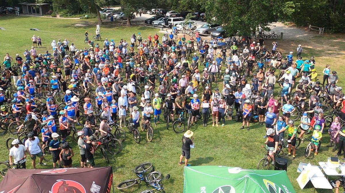Off-road cyclists gather at Lake Crabtree County Park on Saturday May 31, 2025, before one final group ride on the trails there. Wake County closed the trails the following day, a month before its lease with Raleigh-Durham International Airport expires.