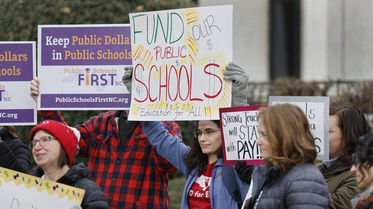 Public school advocates including Marie Dexter, president of the Wake County PTA Council, center, gather outside the N.C. Legislative Building in Raleigh to lobby for more public school funding Jan. 14.