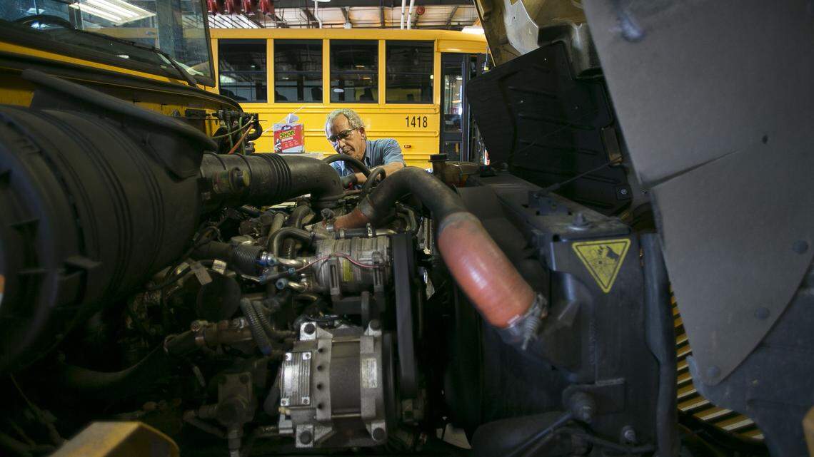 Mechanic Donald Liles services one of the fleet of buses for the Wake County School System at their garage on Wednesday, August 22, 2018 in Raleigh, N.C.