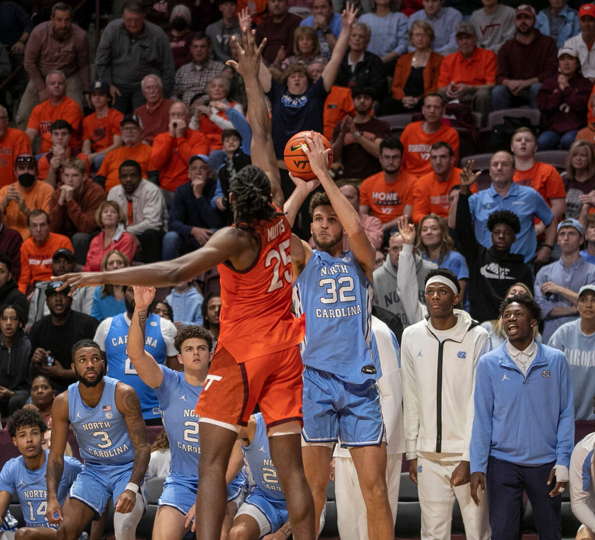 North Carolina’s Pete Nance (32) launches a three point shot against Virginia Tech’s Justyn Mutts (25) during the second half half on Sunday, December 4, 2022 at Cassell Coliseum in Blacksburg, Va. Nance scored 18 points in the Tar Heels’ 80-72 loss.