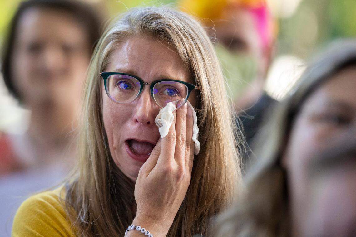 Amanda Dumas of Huntersville, N.C., the parent of trans youth, weeps as she gathers with a group that was not allowed to speak at a public hearing on the Youth Protection Act, during a House Committee on Health meeting on Tuesday, May 2, 2023 at the Legislative Office Building in Raleigh, N.C. The legislation would ban gender-affirming care for minors.