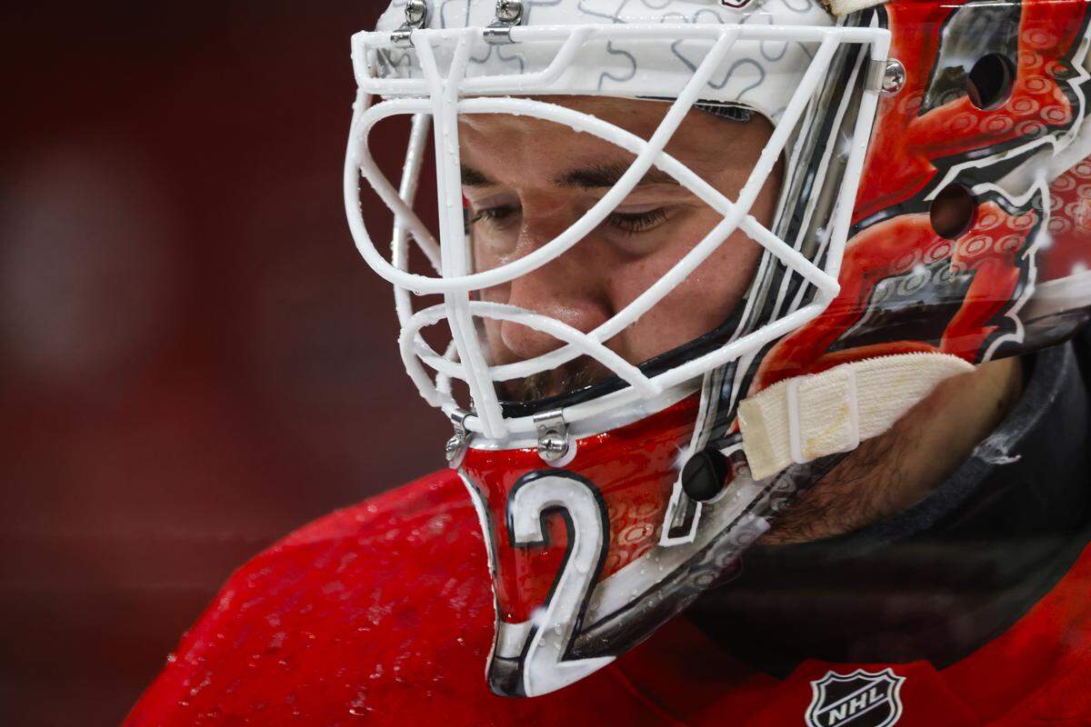 Brandon Bussi of the Carolina Hurricanes is seen in the net during the warmups against the Calgary Flames at Lenovo Center on Sunday in Raleigh.