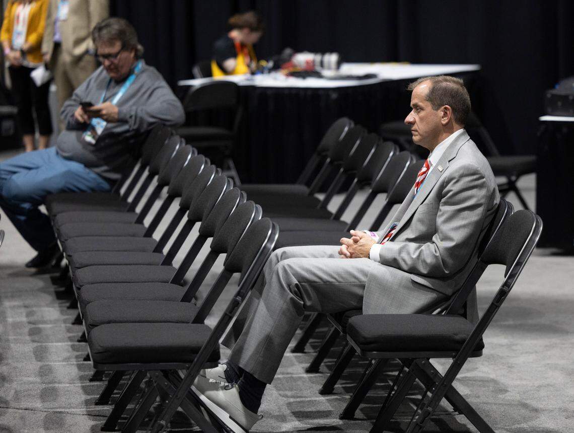 ACC Commissioner Jim Phillips watches N.C. State coach Kevin Keatts, during his post game press conference following the Wolfpack’s loss to Purdue in the NCAA Final Four National Semifinal game on Saturday, April 6, 2024 at State Farm Stadium in Glendale, AZ.