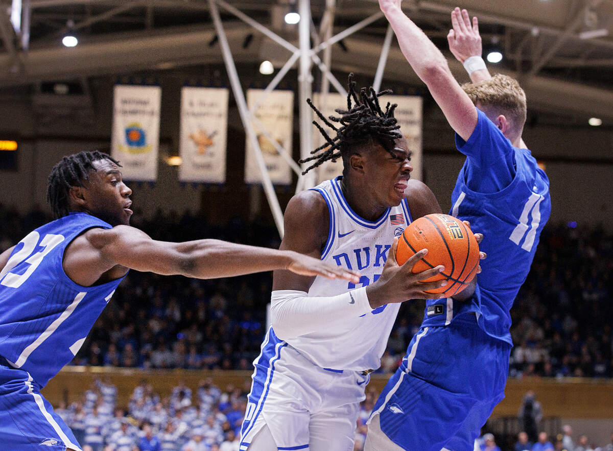 Duke’s Mark Mitchell drives between Hofstra’s Tyler Thomas and Jacco Fritz during the second half of the Blue Devils’ 89-68 win on Tuesday, Dec. 12, 2023, at Cameron Indoor Stadium in Durham, N.C.