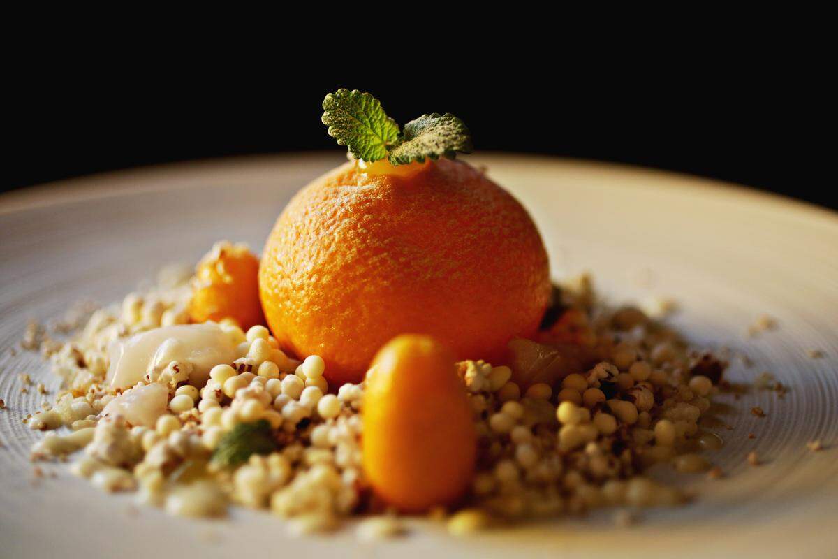 This chicken liver dish with creme fraiche and lemon balm from Herons' is served inside citrus atop a bed of puffed grains.