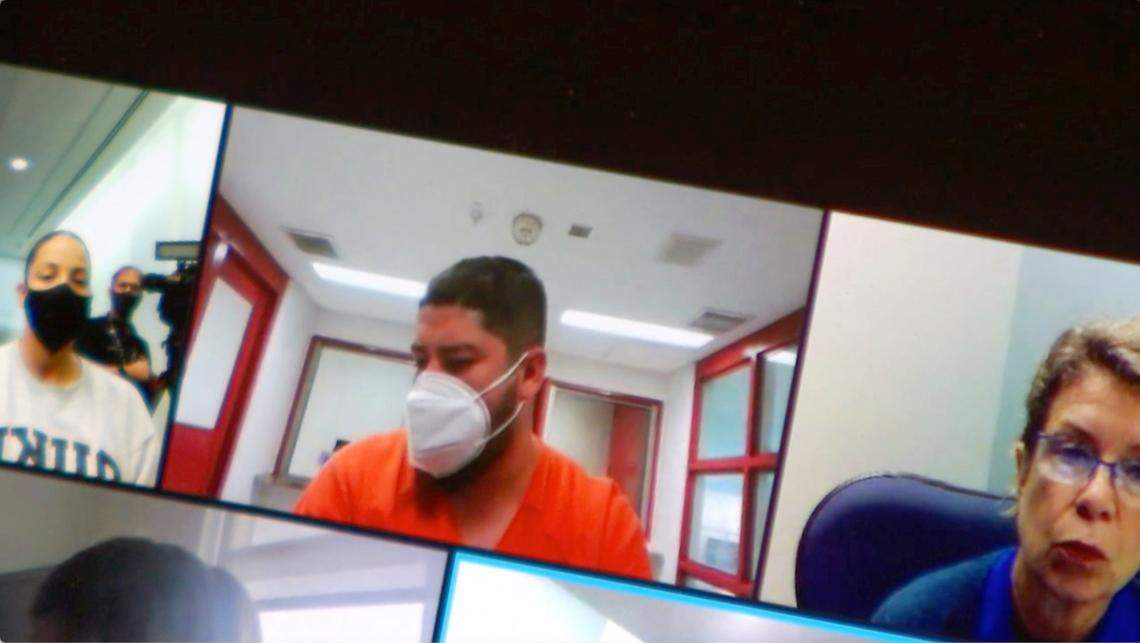Miguel Enrique Salguero-Olivares (center), charged in the 2021 murder of UNC-Chapel Hill student Faith Hedgepeth, makes his first appearance in a Durham, N.C. court via video Friday, Sept. 17, 2021. Salguero-Olivares was arrested Thursday, Sept. 16, 2021.