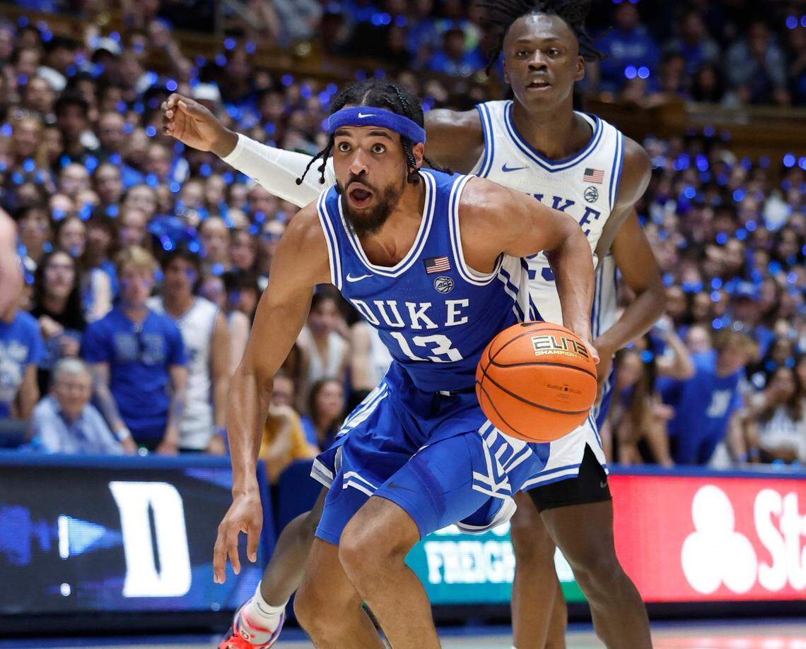 Duke’s Jacob Grandison (13) drives by Mark Mitchell (25) during the Blue-White scrimmage during Duke’s Countdown to Craziness at Cameron Indoor Stadium in Durham, N.C., Friday, Oct. 21, 2022.